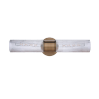 Modern vanity light featuring faux alabaster white glass cylindrical shades with an antique brass finish wall mount for modern bathroom lighting.