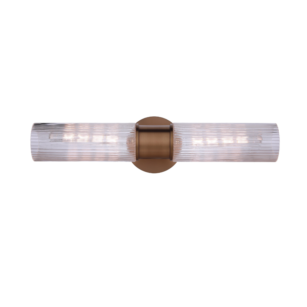 Modern vanity light with double-ended clear ribbed glass cylinders and a antique brass finish wall mount for modern bathroom lighting.
