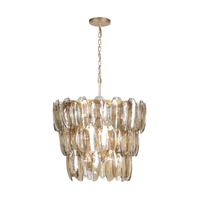 Tiered topaz glass chandelier with individually suspended textured glass panels and a warm gold metal frame.