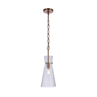 Modern pendant light featuring a handcrafted crackled glass shade, antique brass finished hardware, chain suspension, and exposed Edison-style bulb.
