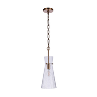 Modern pendant light featuring a handcrafted crackled glass shade, antique brass finished hardware, chain suspension, and exposed Edison-style bulb.