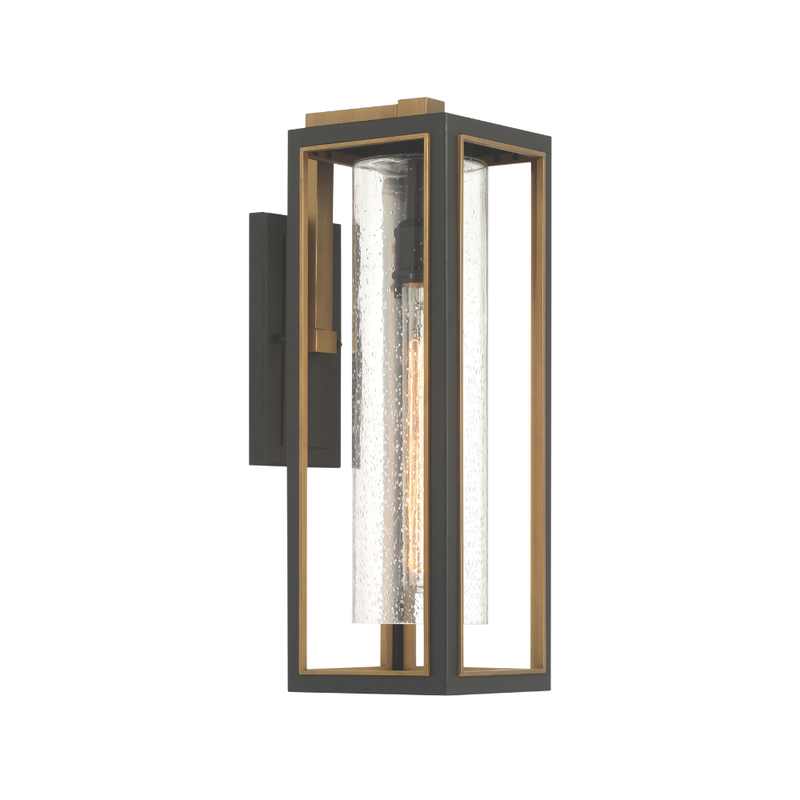 Modern outdoor wall lantern with black frame, brass accents, and seeded glass cylinder shade