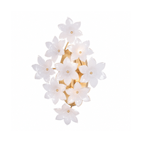 Gold wall sconce with swirl white glass flower petals in a sculptural design