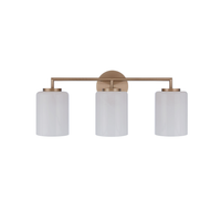 Modern 3-light bathroom vanity light featuring antique brass finish metal construction with three faux alabaster white glass cylinder shades in a minimalist transitional design.