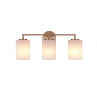 Modern 3-light bathroom vanity light featuring antique brass finish metal construction with three faux alabaster white glass cylinder shades in a minimalist transitional design.