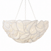 White sculptural chandelier with layered leaf-like design and soft ambient lighting