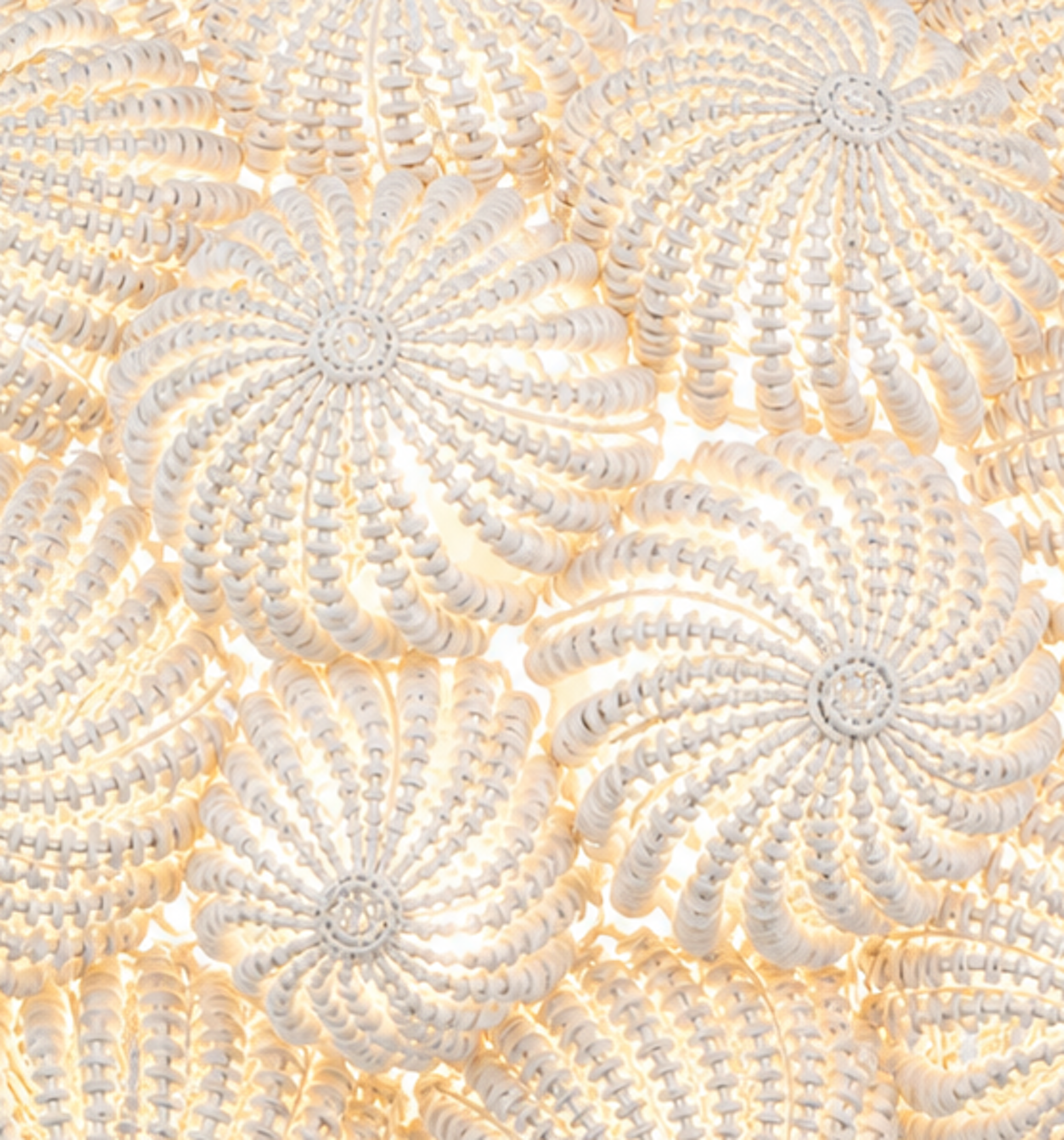White coco bead chandelier with floral medallion design and soft ambient lighting